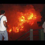 People look at a fire approaching Funchal, on the Portuguese island of Madeira